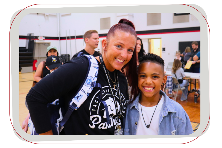 adult and male student smiling at camera